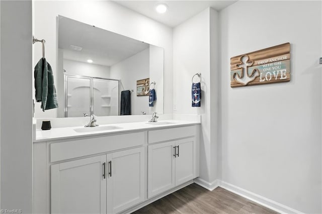 4514 Heatherly Rd, Winston-Salem, NC 27105 - bathroom with a stall shower, wood finished floors, double vanity, and recessed lighting