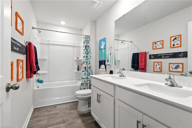 4514 Heatherly Rd, Winston-Salem, NC 27105 - bathroom with shower / tub combo with curtain, double vanity, wood finished floors, and recessed lighting