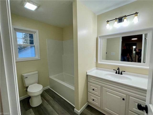 full bathroom with vanity, toilet, wood-type flooring, and bathtub / shower combination