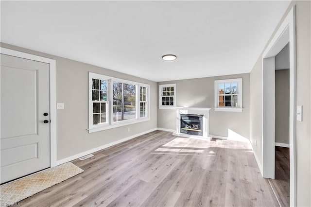 unfurnished living room featuring light wood-type flooring