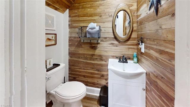 bathroom with wood walls, toilet, and vaulted ceiling