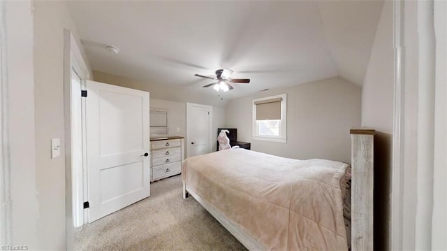 carpeted bedroom featuring vaulted ceiling and ceiling fan