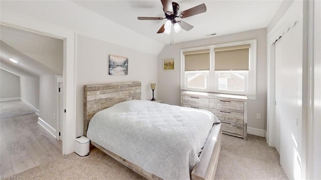 bedroom featuring ceiling fan, lofted ceiling, and light wood-type flooring