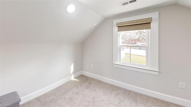 additional living space with light carpet and lofted ceiling