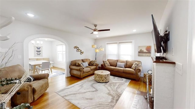 living room with hardwood / wood-style flooring and ceiling fan