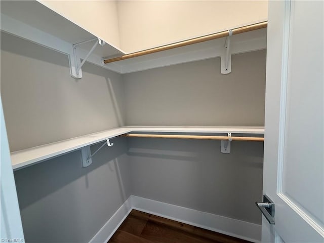 3048 Island Dr, Northtopsail Beach, NC 28460 - walk in closet with dark wood-style flooring