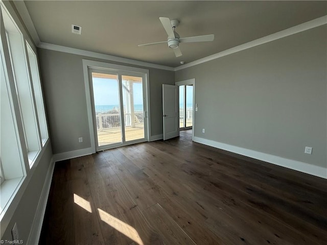 3048 Island Dr, Northtopsail Beach, NC 28460 - spare room featuring dark wood-style flooring, ornamental molding, and baseboards