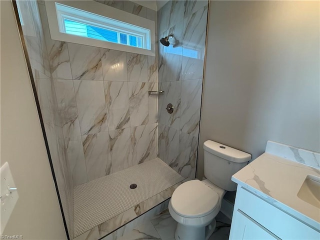 3048 Island Dr, Northtopsail Beach, NC 28460 - bathroom featuring marble finish floor, vanity, toilet, and a tile shower