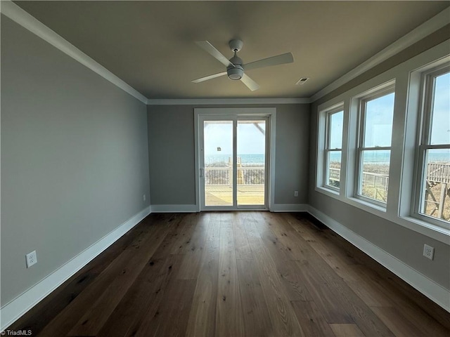 3048 Island Dr, Northtopsail Beach, NC 28460 - unfurnished room featuring dark wood-style flooring, ornamental molding, baseboards, visible vents, and a ceiling fan