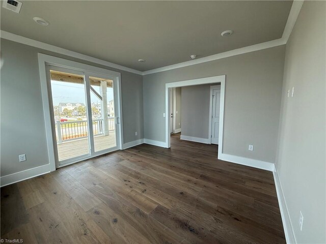3048 Island Dr, Northtopsail Beach, NC 28460 - unfurnished room with baseboards, visible vents, crown molding, and dark wood finished floors
