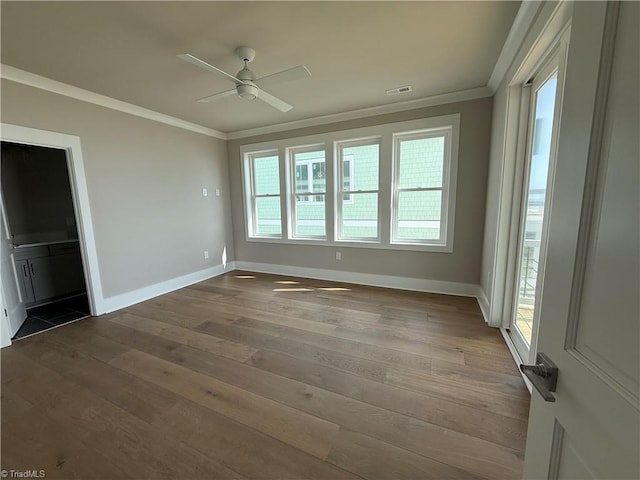3048 Island Dr, Northtopsail Beach, NC 28460 - spare room featuring baseboards, crown molding, wood finished floors, and ceiling fan