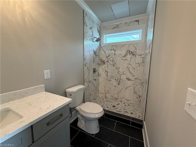 3048 Island Dr, Northtopsail Beach, NC 28460 - bathroom featuring a tile shower, toilet, tile patterned floors, and vanity
