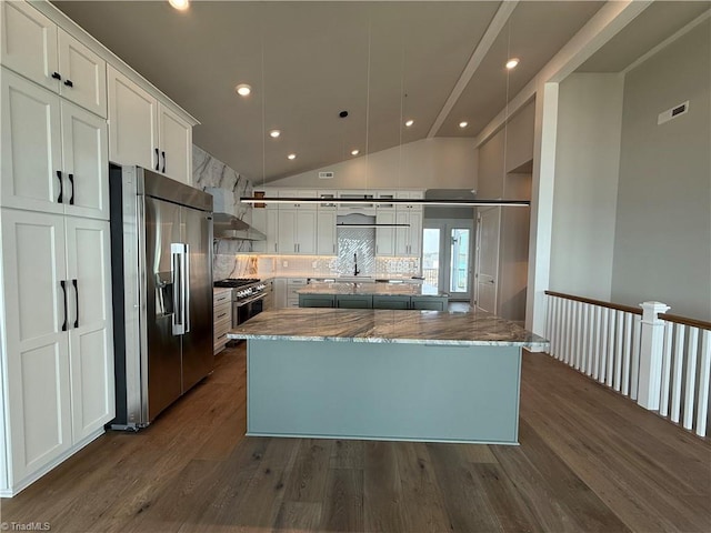 3048 Island Dr, Northtopsail Beach, NC 28460 - kitchen featuring stainless steel appliances, dark wood finished floors, backsplash, a kitchen island, and white cabinets