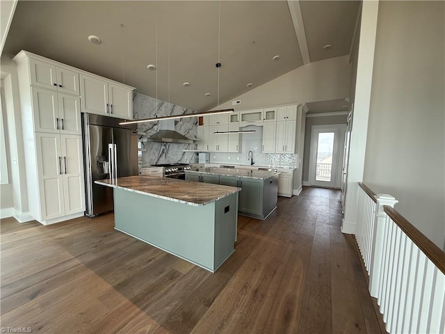 3048 Island Dr, Northtopsail Beach, NC 28460 - kitchen featuring a kitchen island, high quality fridge, stainless steel gas range oven, dark wood-style floors, and wall chimney range hood
