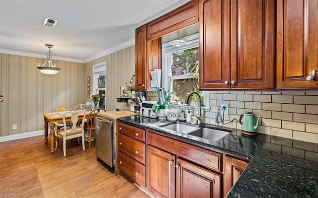 3941 Vest Mill Rd, Winston-Salem, NC 27103 - kitchen with a sink, decorative backsplash, light wood-style floors, ornamental molding, and dark stone countertops
