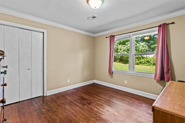 3941 Vest Mill Rd, Winston-Salem, NC 27103 - unfurnished bedroom featuring wood finished floors, baseboards, crown molding, and a closet