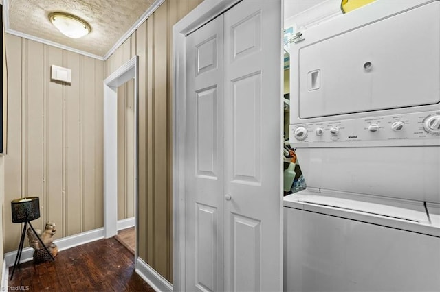 3941 Vest Mill Rd, Winston-Salem, NC 27103 - laundry room with stacked washing machine and dryer, crown molding, baseboards, wood finished floors, and a textured ceiling