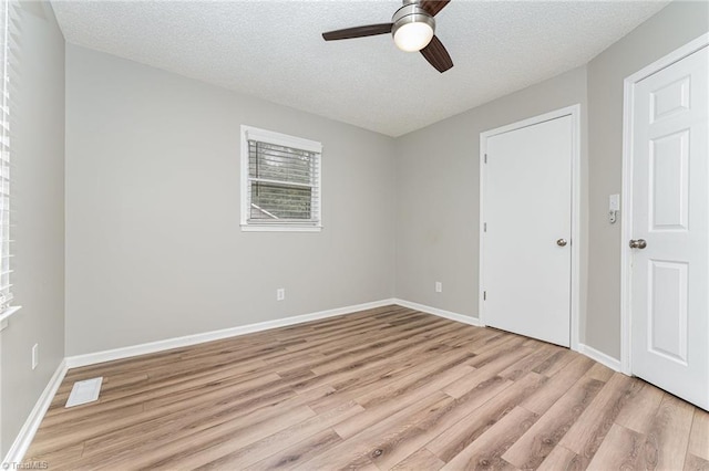 4104 Old Greensboro Rd, Winston-Salem, NC 27101 - unfurnished bedroom with light wood finished floors, a textured ceiling, baseboards, and ceiling fan