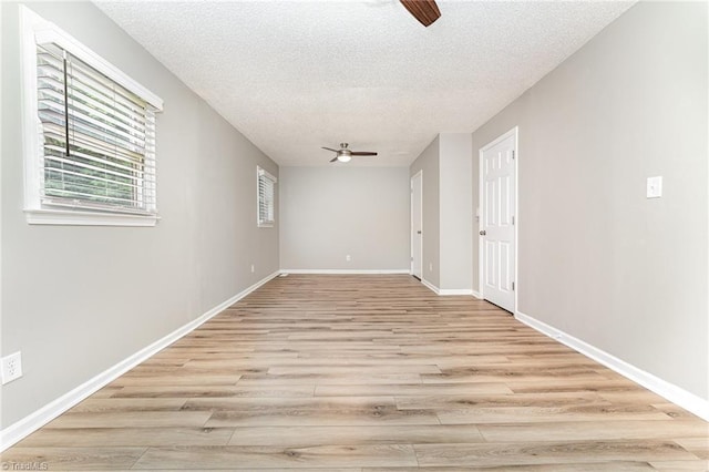 4104 Old Greensboro Rd, Winston-Salem, NC 27101 - empty room featuring a ceiling fan, a textured ceiling, light wood-style floors, and baseboards