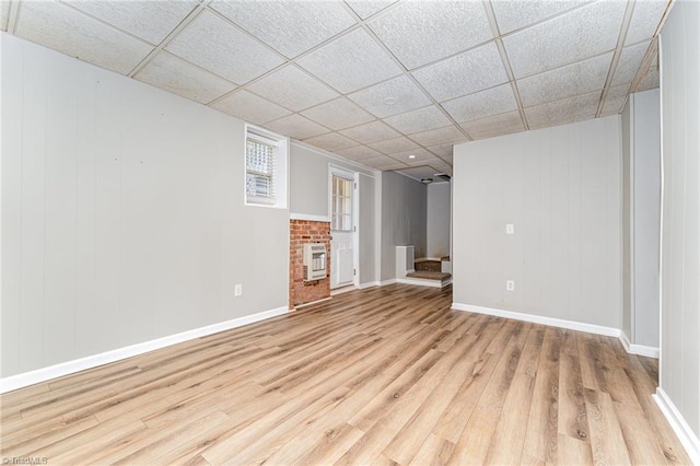 4104 Old Greensboro Rd, Winston-Salem, NC 27101 - below grade area featuring wood finished floors, heating unit, a paneled ceiling, baseboards, and a fireplace