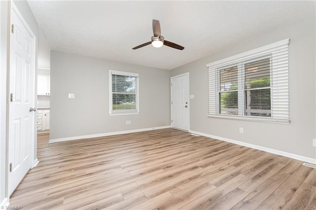 4104 Old Greensboro Rd, Winston-Salem, NC 27101 - spare room featuring ceiling fan, light wood-type flooring, baseboards, and a textured ceiling