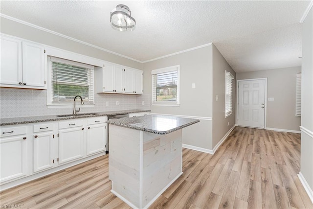 4104 Old Greensboro Rd, Winston-Salem, NC 27101 - kitchen featuring a sink, light wood finished floors, light stone counters, white cabinetry, and a textured ceiling