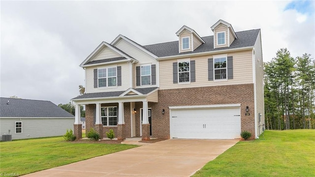 craftsman-style house featuring cooling unit, a porch, a garage, and a front yard