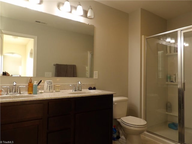 5304 Smoky Ridge Ln, Winston-Salem, NC 27127 - bathroom with double vanity, toilet, and a stall shower
