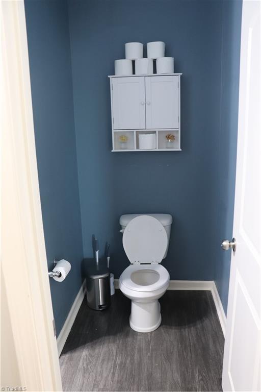 5304 Smoky Ridge Ln, Winston-Salem, NC 27127 - bathroom featuring toilet, baseboards, and wood finished floors