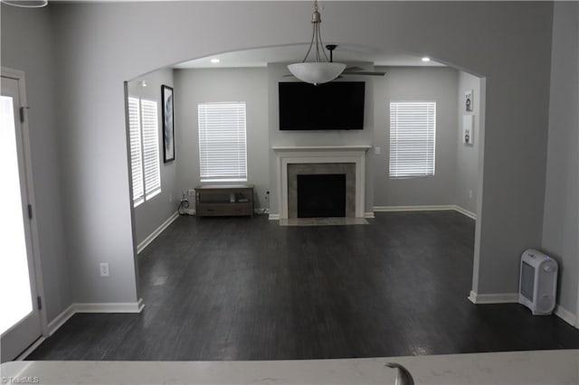 5304 Smoky Ridge Ln, Winston-Salem, NC 27127 - unfurnished living room featuring a fireplace with flush hearth, dark wood-type flooring, arched walkways, and recessed lighting