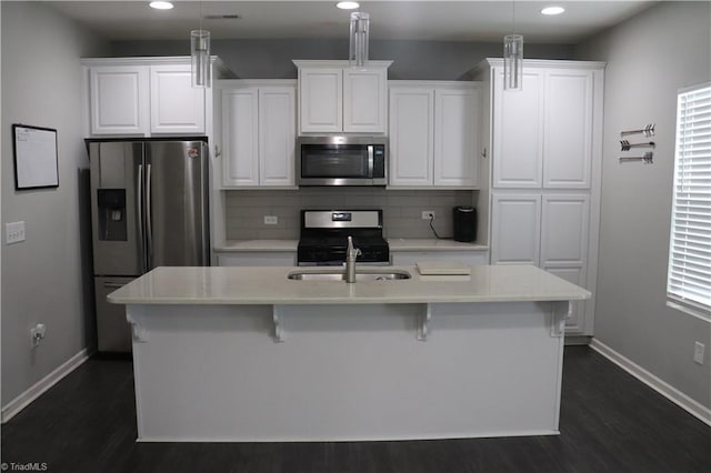 5304 Smoky Ridge Ln, Winston-Salem, NC 27127 - kitchen with stainless steel appliances, dark wood-style flooring, recessed lighting, baseboards, and white cabinetry