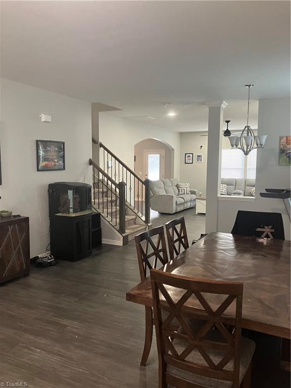5304 Smoky Ridge Ln, Winston-Salem, NC 27127 - dining space with stairs, wood finished floors, and arched walkways