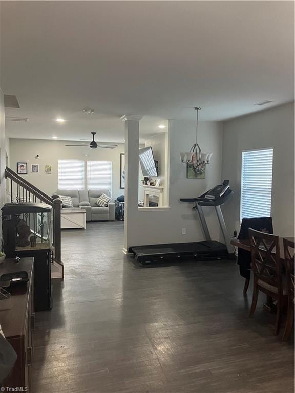 5304 Smoky Ridge Ln, Winston-Salem, NC 27127 - exercise room with dark wood-type flooring, ceiling fan, and a chandelier