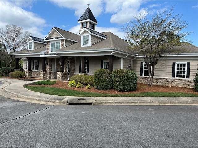 view of front of home featuring a porch and stone siding