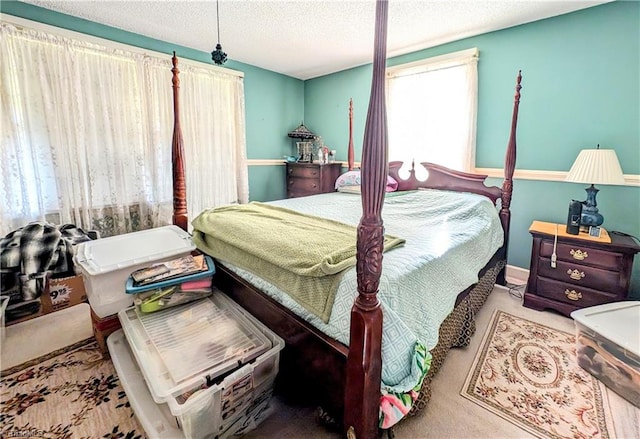 carpeted bedroom with a textured ceiling