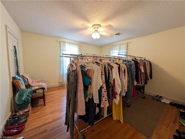 walk in closet featuring hardwood / wood-style flooring and ceiling fan