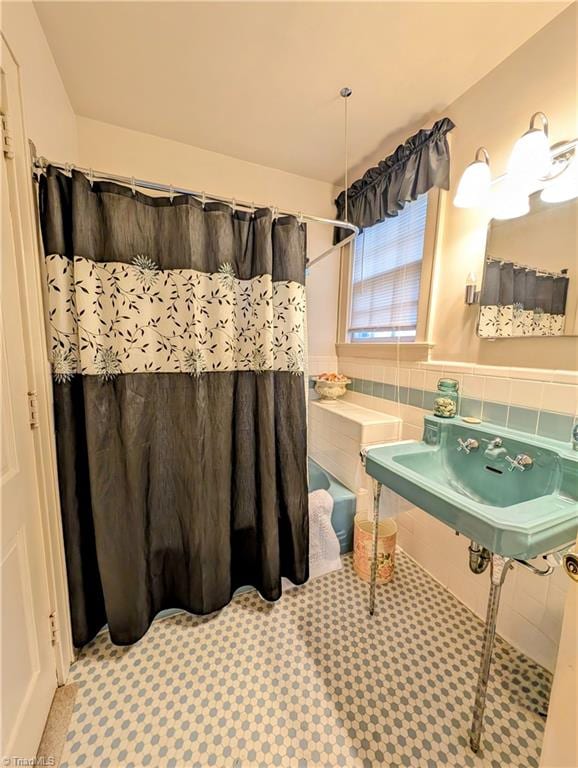 bathroom with tile patterned floors and a shower with shower curtain