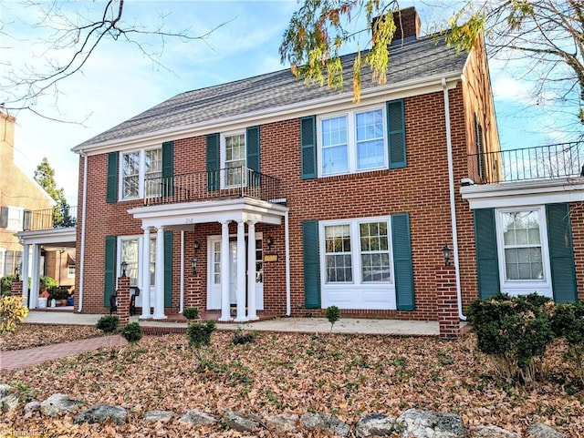 colonial inspired home with a balcony