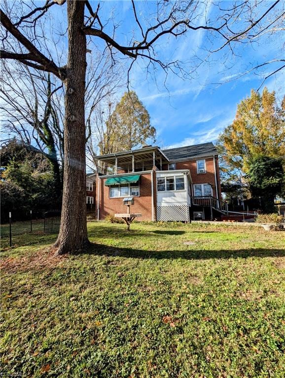 back of house featuring a yard