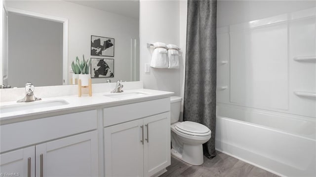 2124 Monk Dr, Haw River, NC 27258 - full bath featuring toilet, wood finished floors, double vanity, and shower / bath combo with shower curtain