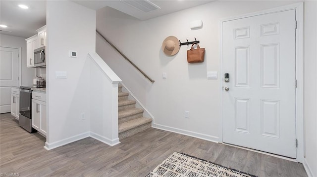 2124 Monk Dr, Haw River, NC 27258 - entrance foyer with light wood-style floors, recessed lighting, baseboards, and stairs