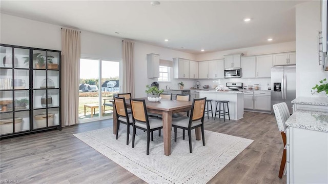 dining area featuring recessed lighting and wood finished floors