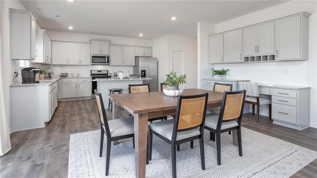 dining area featuring recessed lighting and wood finished floors