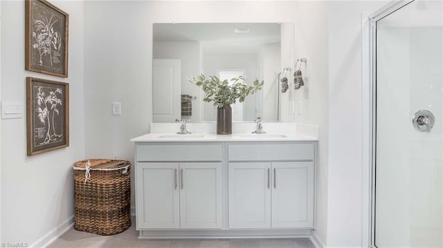 bathroom with a shower stall and a sink