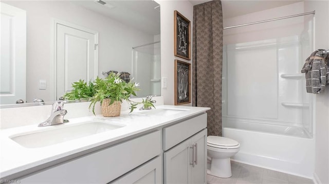 bathroom featuring a sink, visible vents, toilet, and double vanity