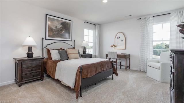 bedroom featuring visible vents, baseboards, and light colored carpet