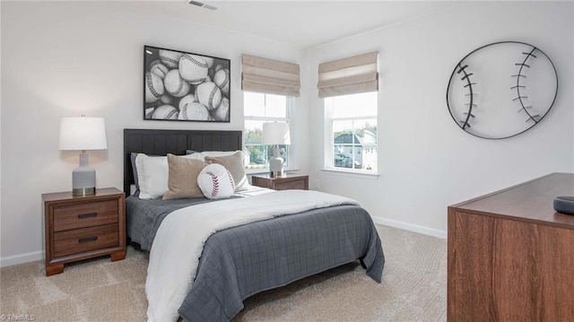 carpeted bedroom with visible vents and baseboards