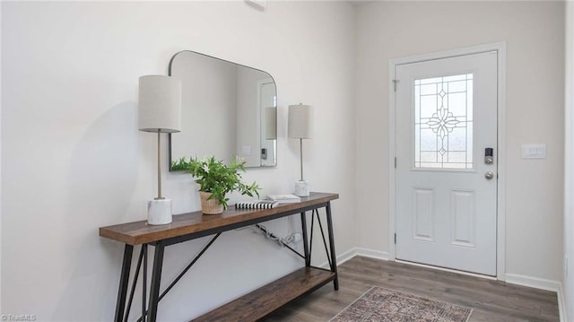 entrance foyer featuring baseboards and wood finished floors