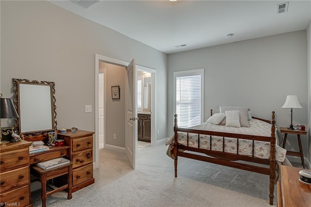 carpeted bedroom featuring connected bathroom