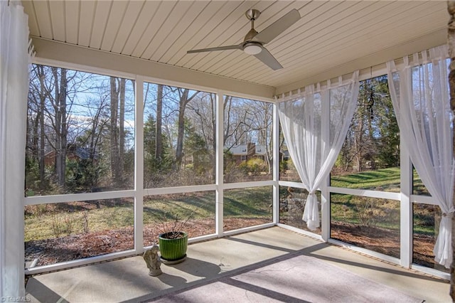 unfurnished sunroom with plenty of natural light and ceiling fan